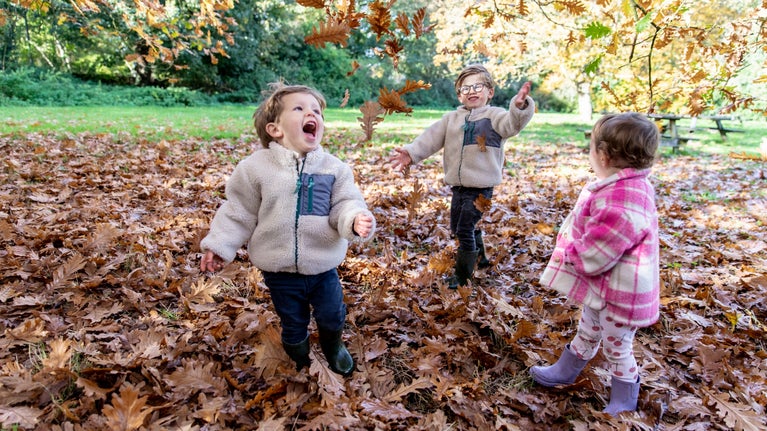 Children enjoying Autumn leaves